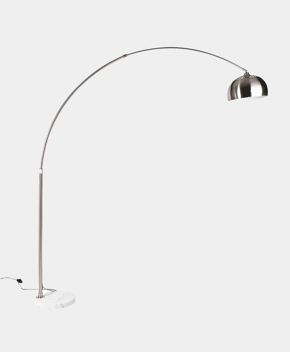 Close-up of a modern arc floor lamp's metallic frame and heavy white marble base.