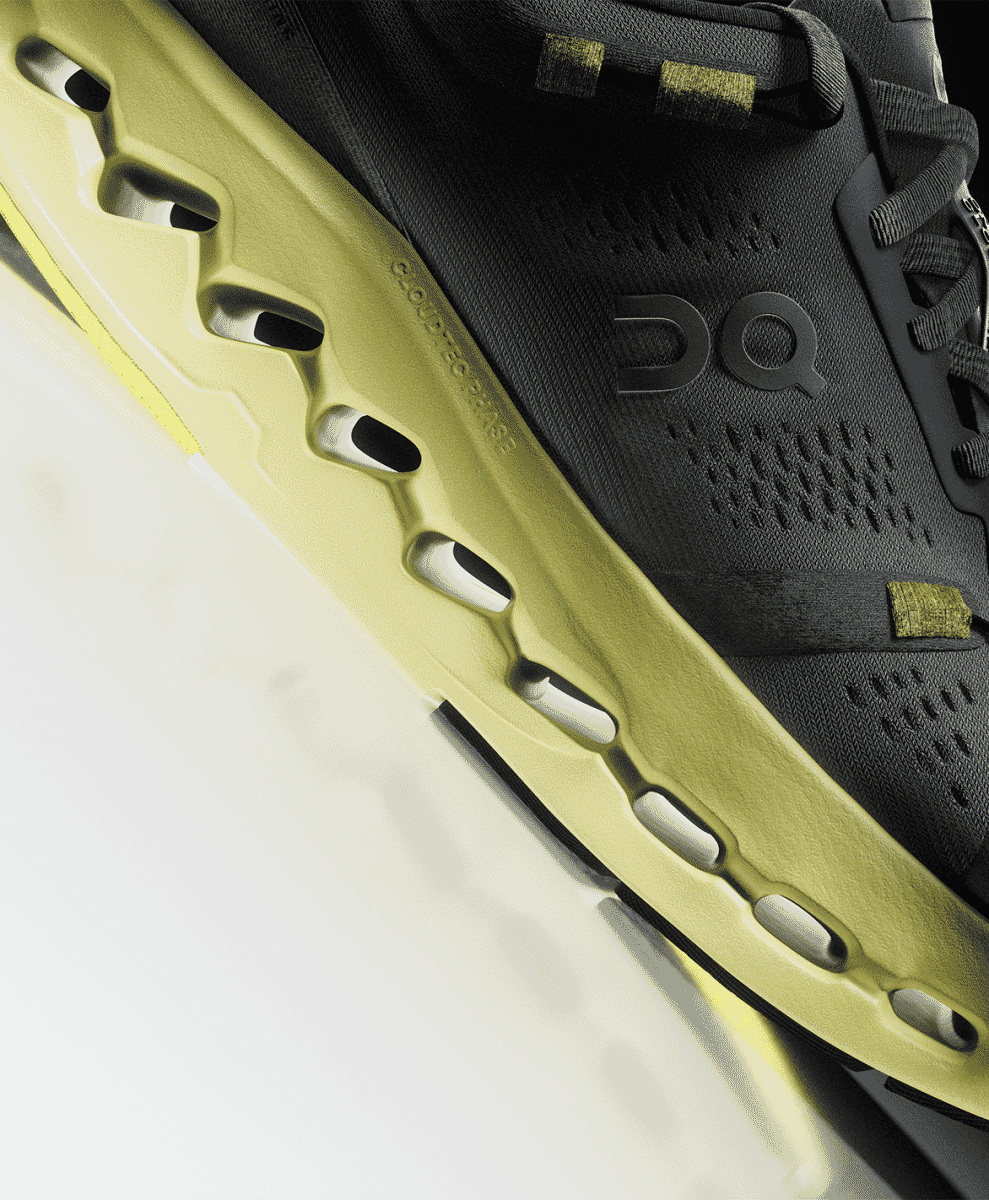 Close-up of a vibrant lime green running shoe sole featuring 'CLOUDTEC PHASE' branding.