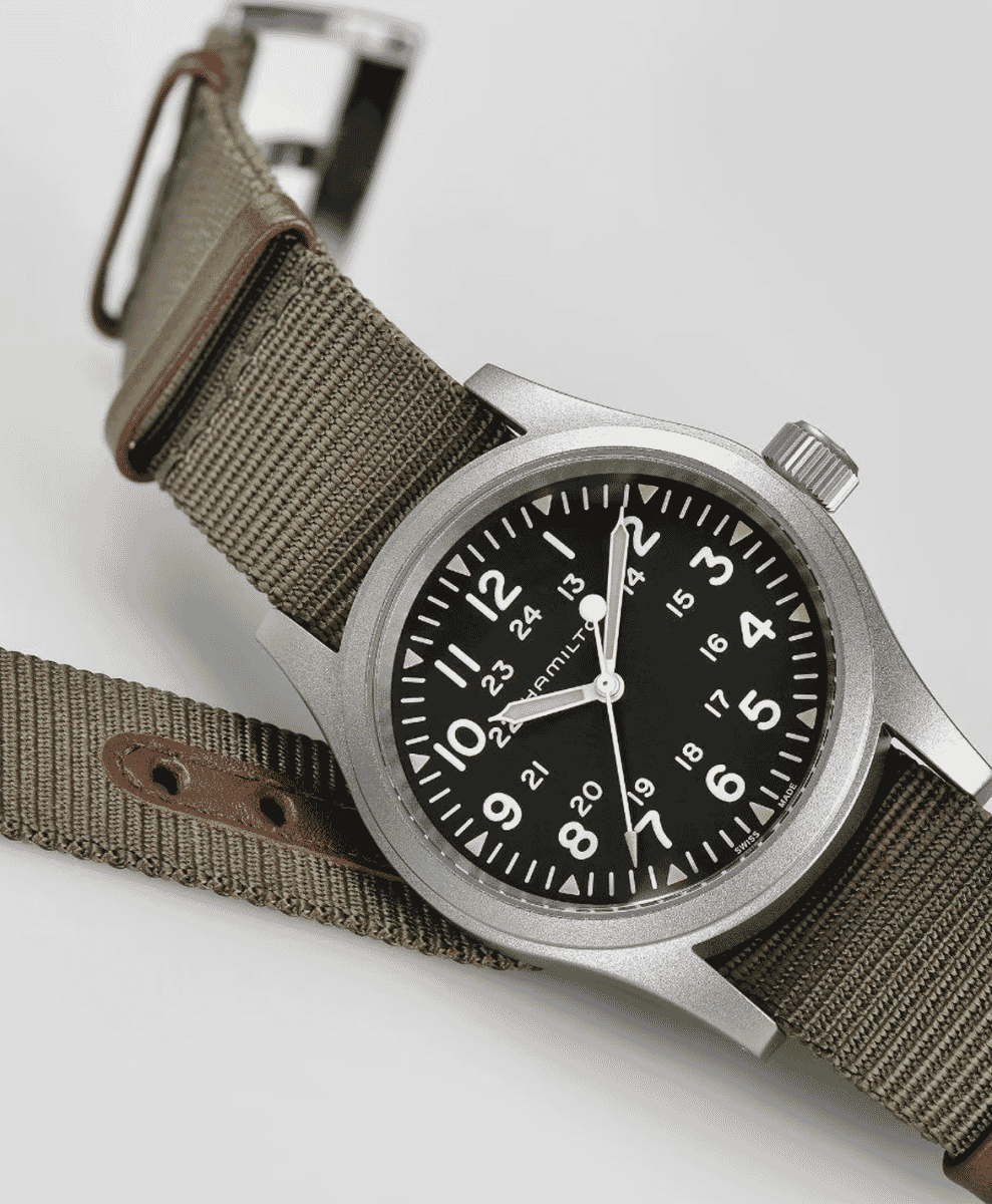 Hamilton military-style watch with an olive green NATO strap on a white background.
