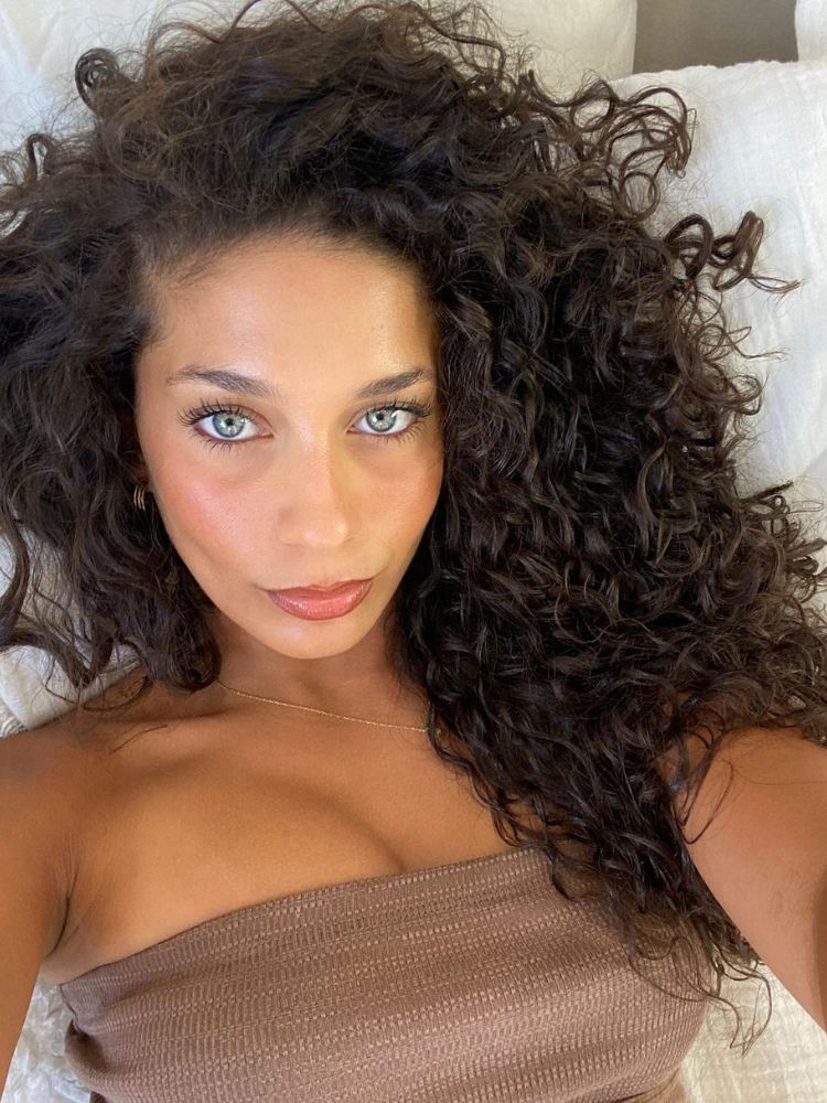 High-shine, healthy-looking dark brunette hair styled in a sleek manner.