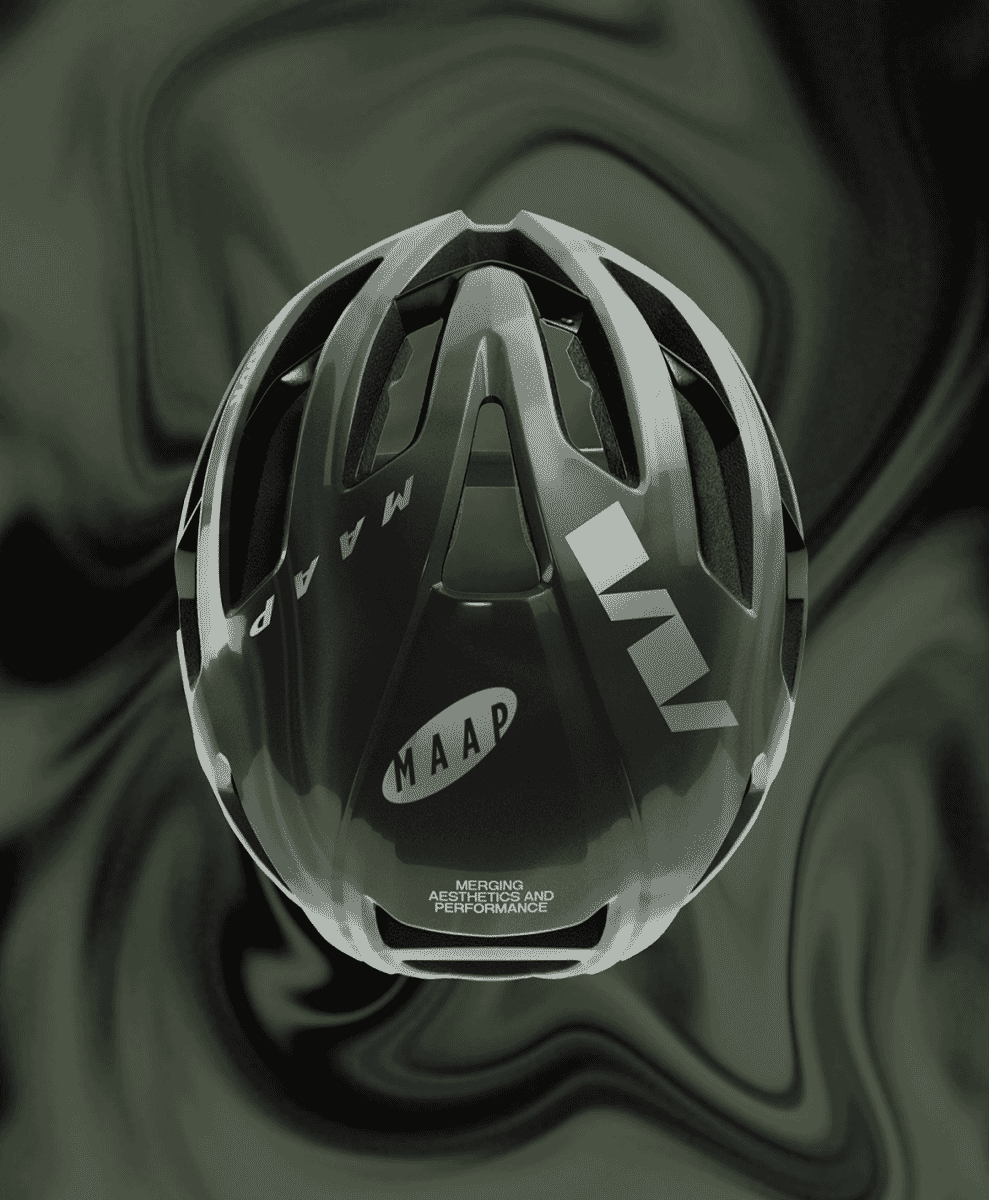 Aerodynamic MAAP cycling helmet with prominent ventilation slots displayed against a dark abstract background.