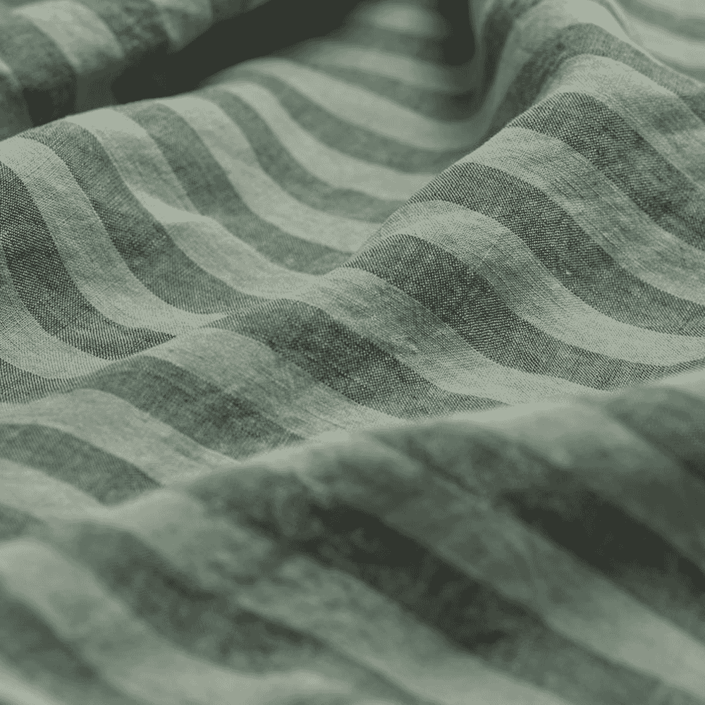 Macro detail of muted green striped linen fabric showing its natural weave and texture.