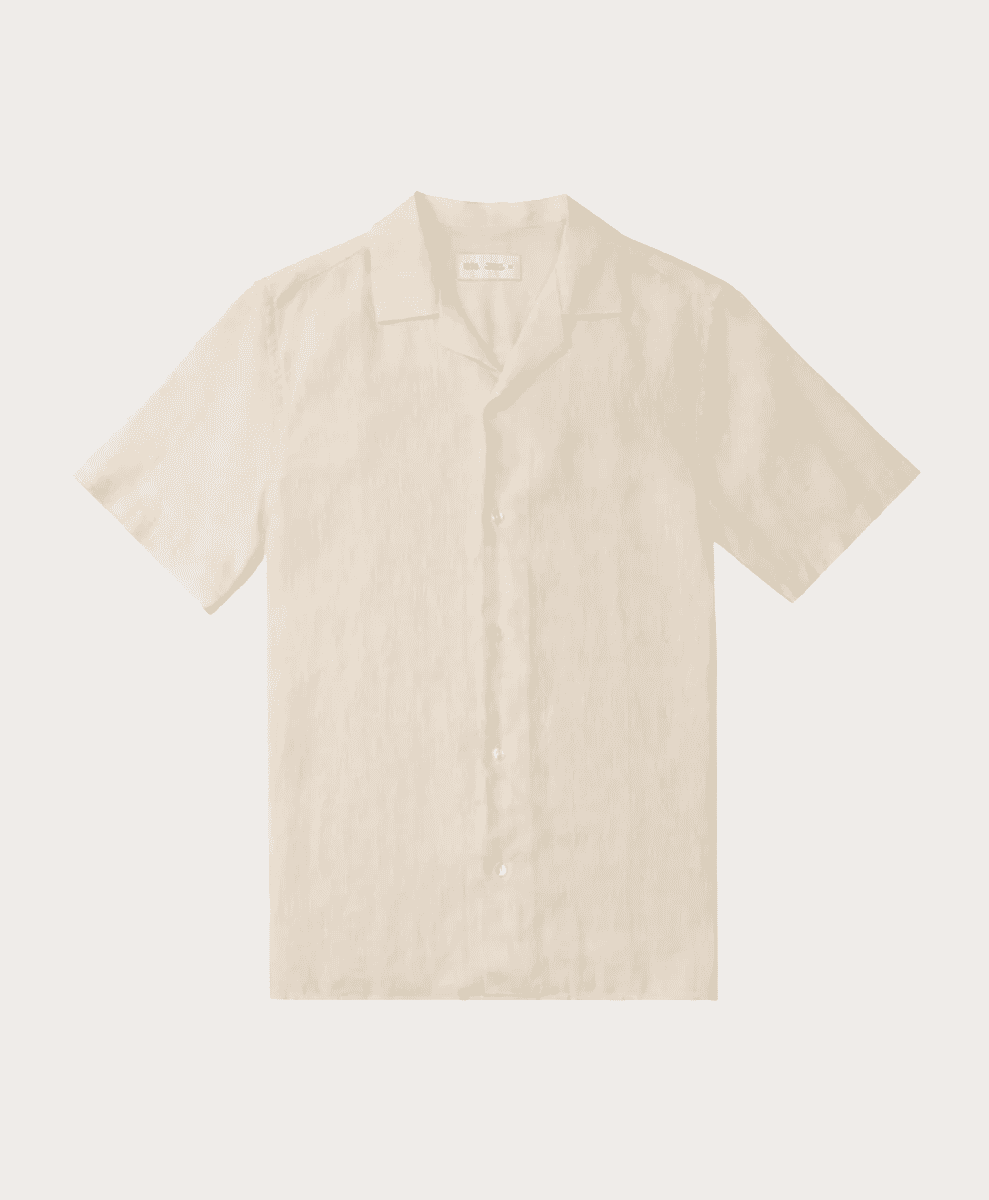 Flat lay of a cream-colored short-sleeved camp-collar linen shirt.