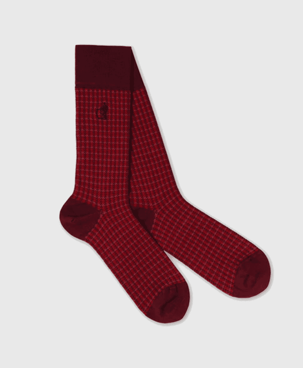 A pair of men's red houndstooth pattern dress socks.