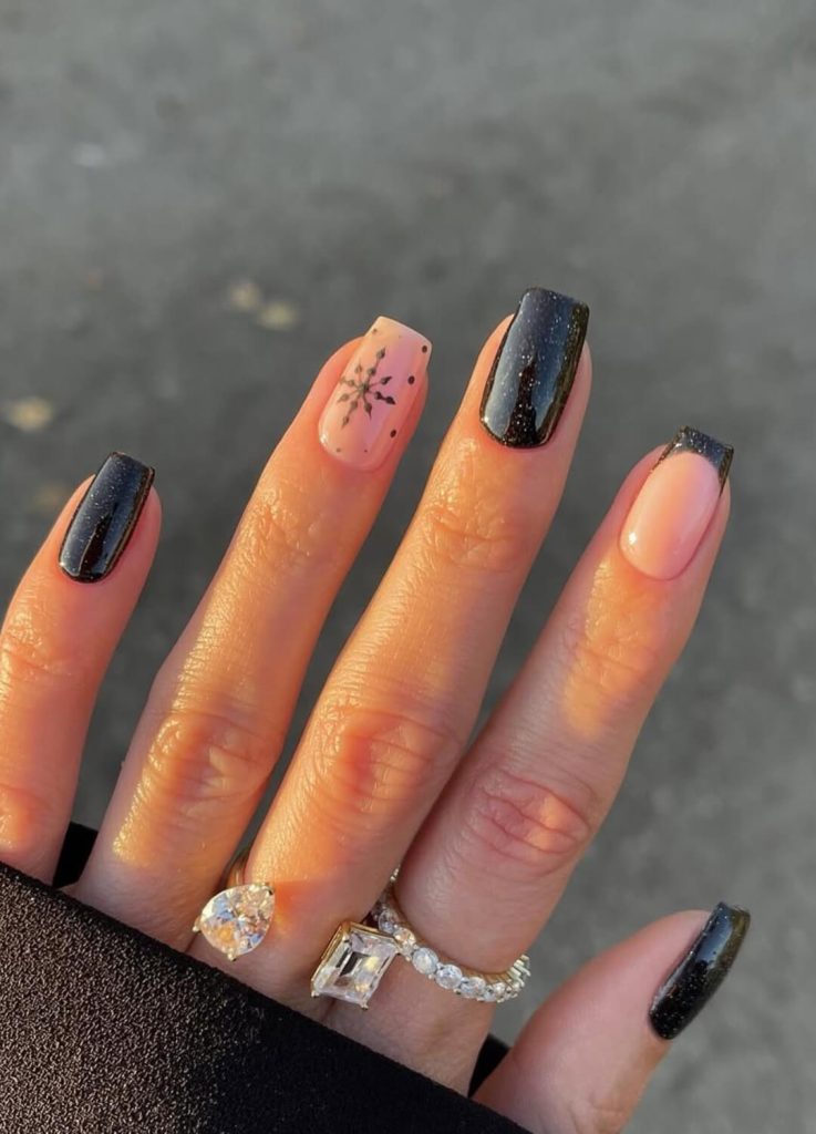 Geometric holiday nail art using mixed gold and silver foil accents.