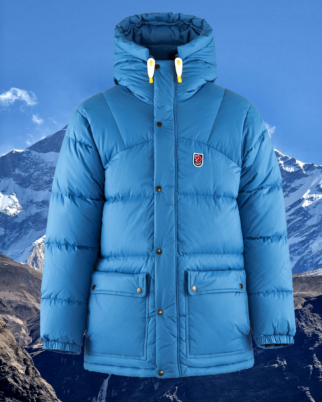 A light blue Fjällräven puffer jacket with a hood against a snowy mountain background.