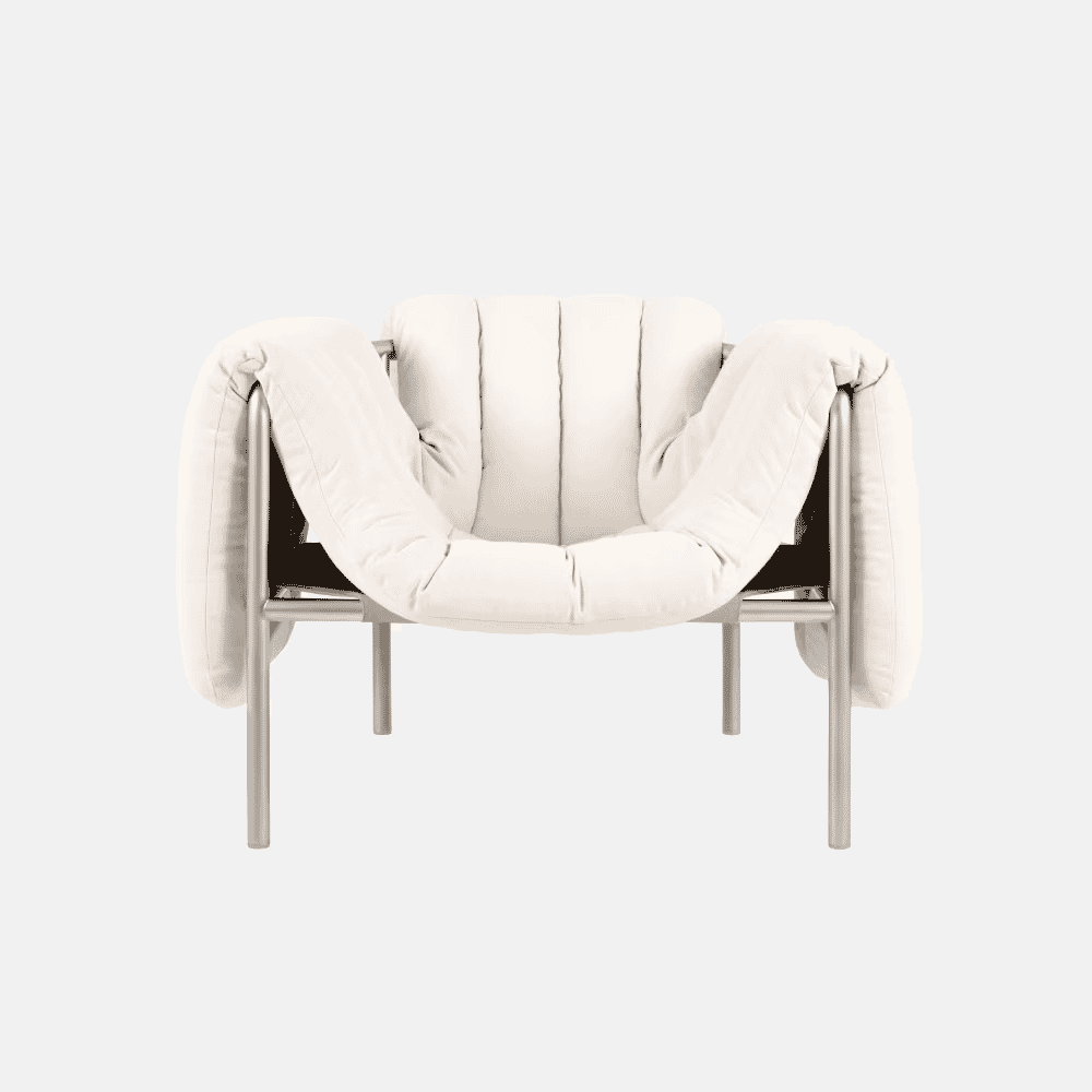 A modern sculptural white armchair with a black metal frame.