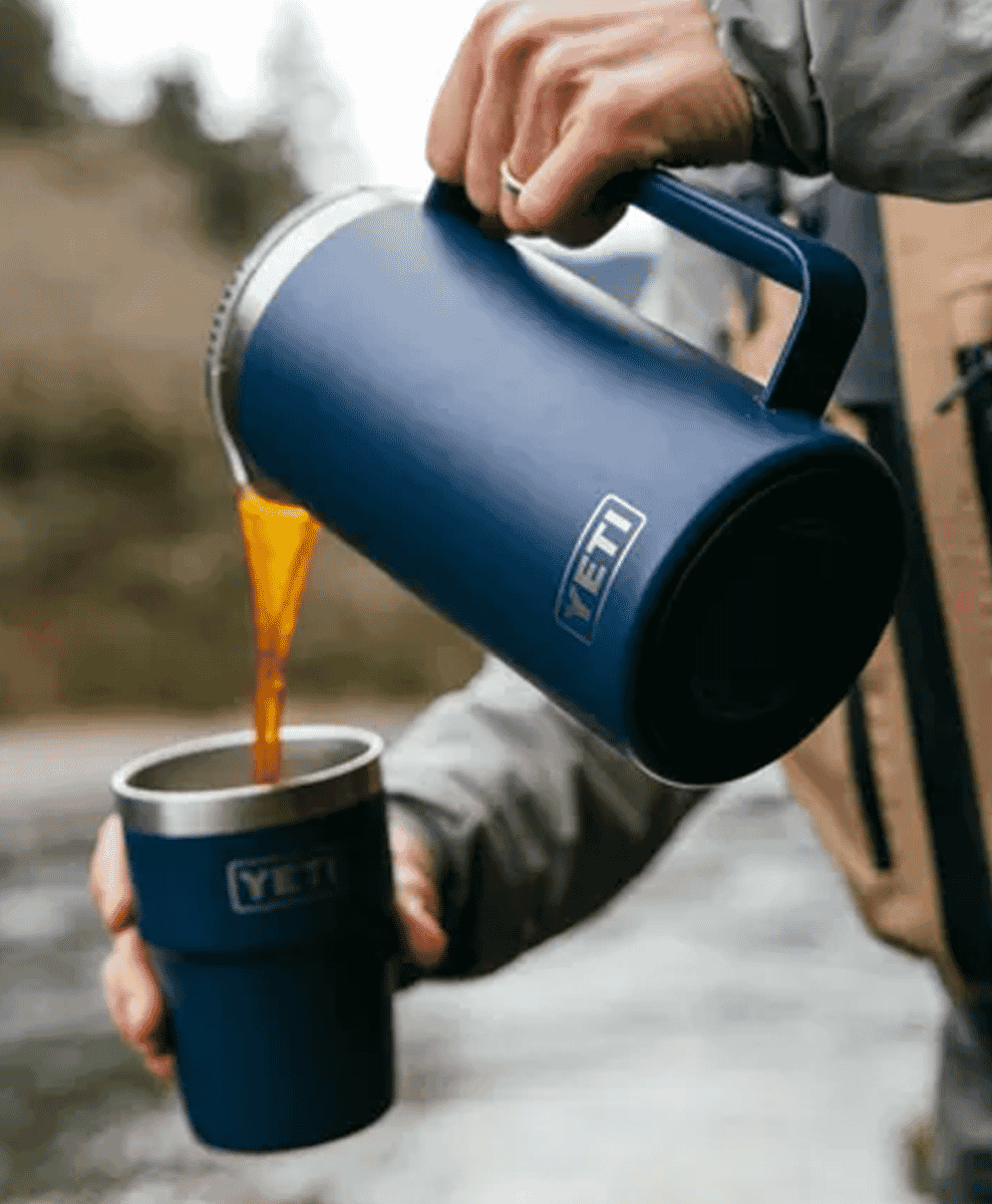 Blue YETI thermal pitcher being used in a cold-weather outdoor setting.