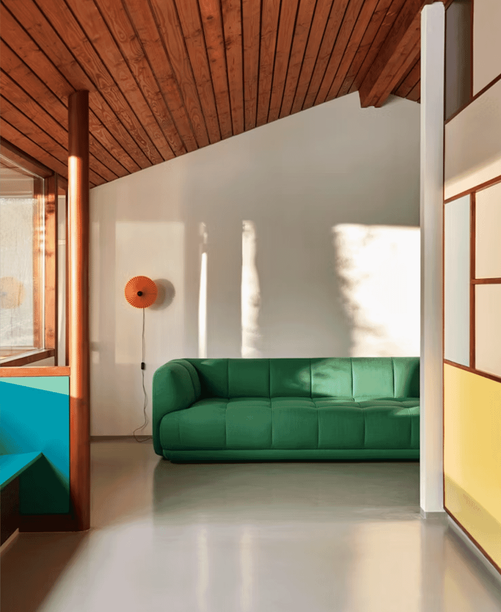 Green HAY Quilton modular sofa in a minimalist room with natural light.