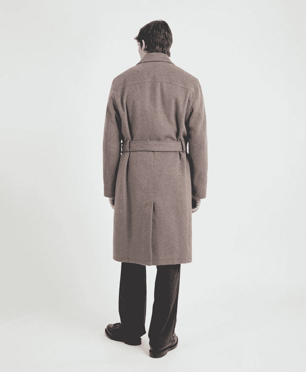 Back view of a man in a belted, knee-length brown wool coat.
