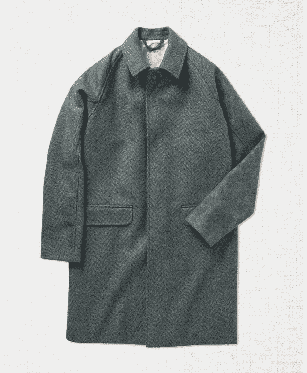 A gray herringbone wool coat with a classic collar displayed flat.