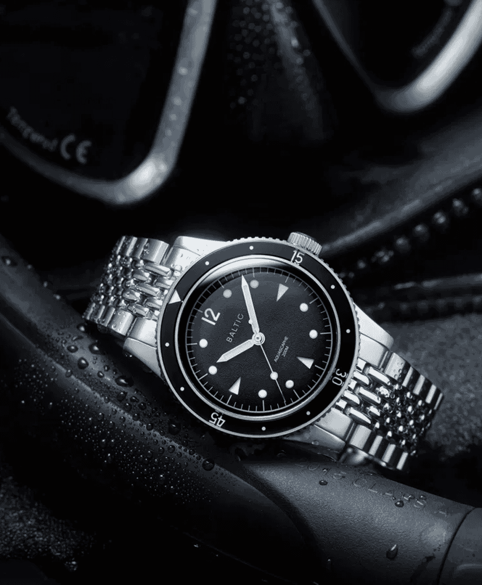Baltic Aquascaphe watch on a wet dark surface with diving gear.