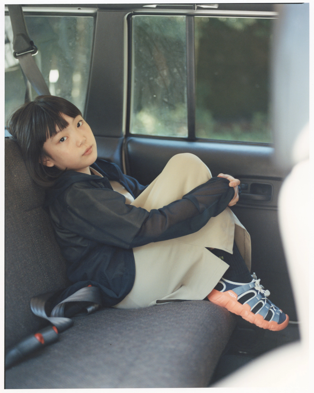 Relaxed lifestyle shot of the sandals placed next to a Snow Peak fire pit at sunset.
