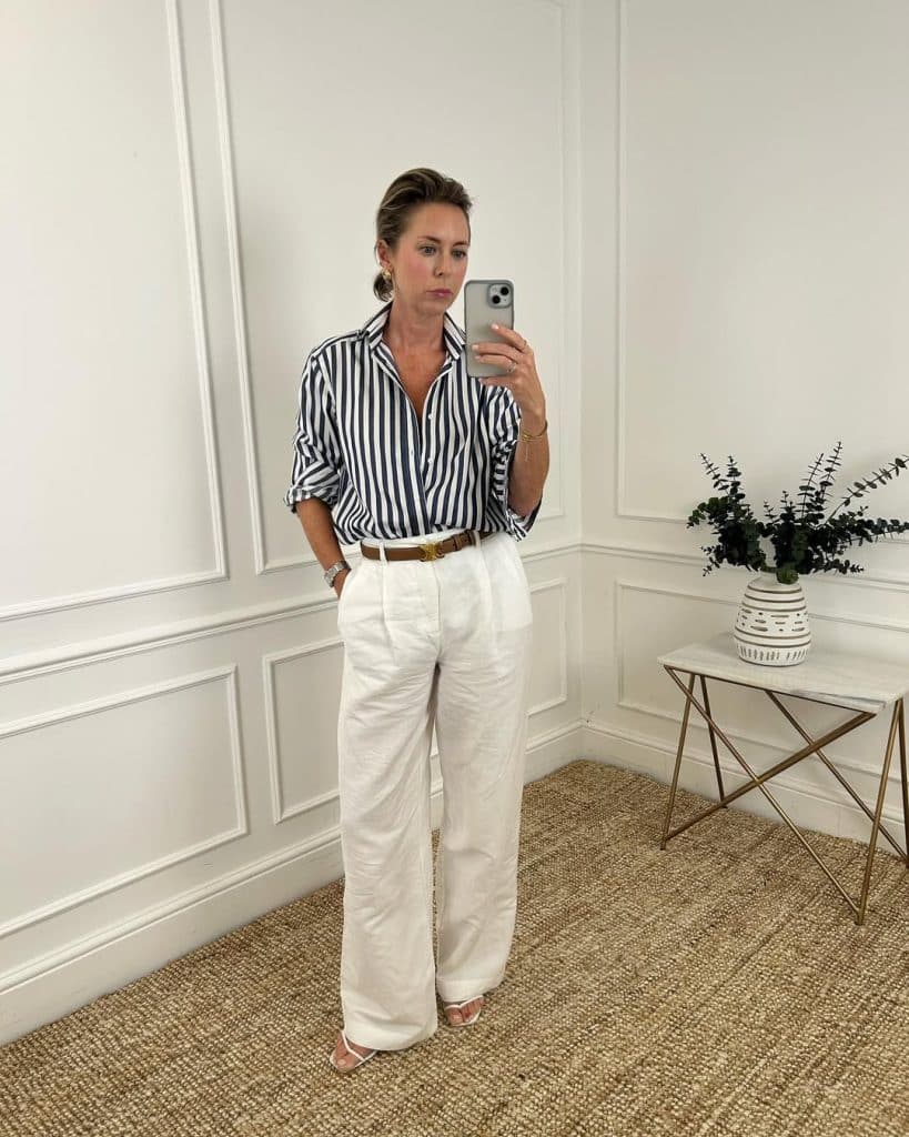 A minimalist neutral outfit accented with a bold red accessory.