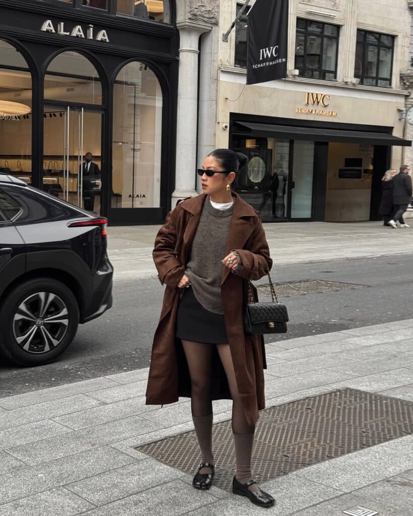 Professional layering featuring a classic trench coat over a business outfit.