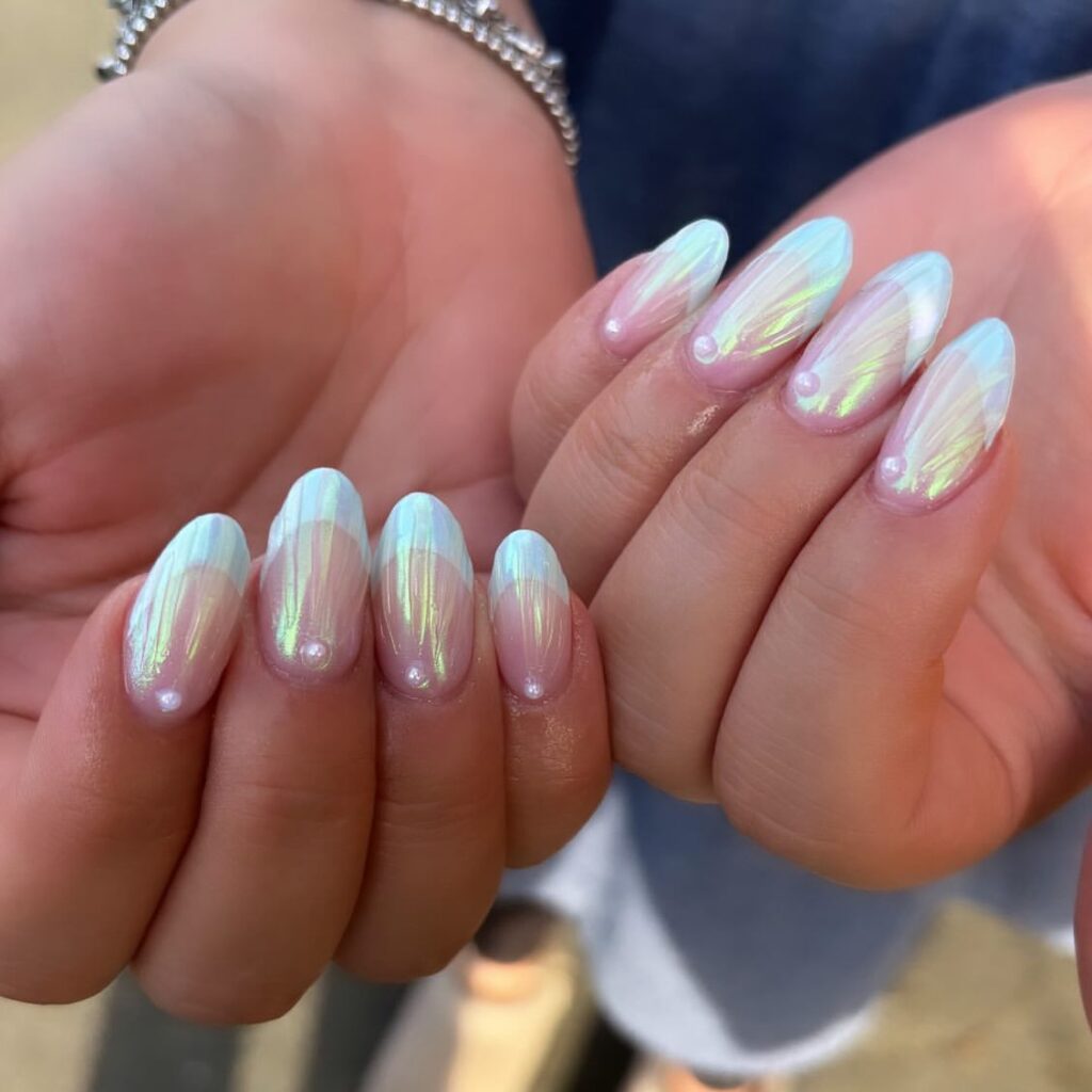 Light blue 3D seashell nail art with raised ridges and pearl accents.