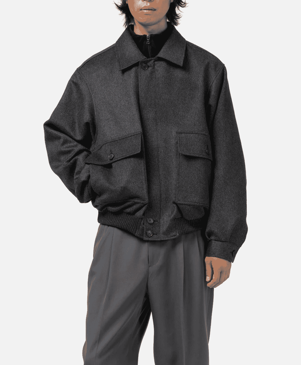 Model in a charcoal gray wool-blend bomber jacket and matching trousers.