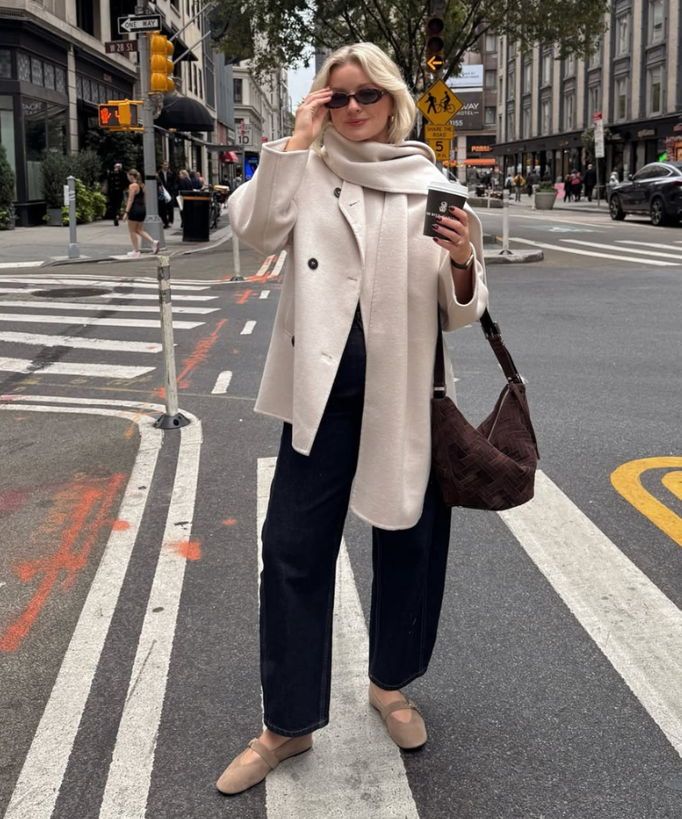 Street style shot of @laura.byrnes in a heavy wool coat and scarf paired with Mary Janes.