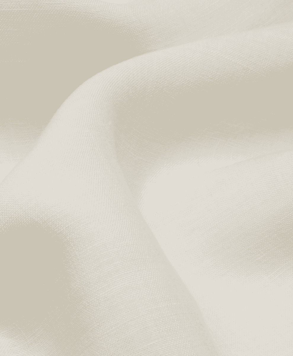 Macro shot of soft cream-colored linen fabric with elegant folds.