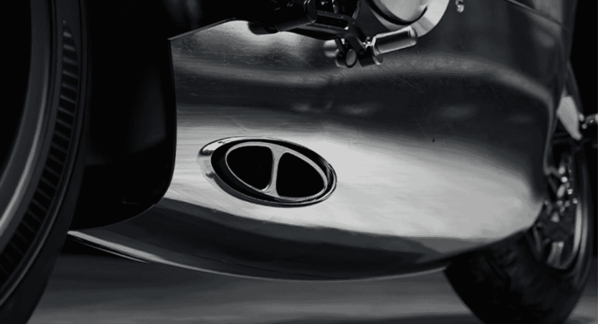 Macro close-up of the polished chrome dual-tube exhaust pipe on a high-performance motorcycle.