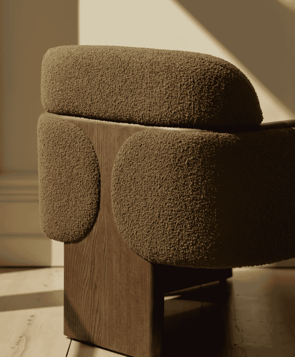 Close-up of the Soho Home Eddie armchair with textured bouclé and a solid wood frame.