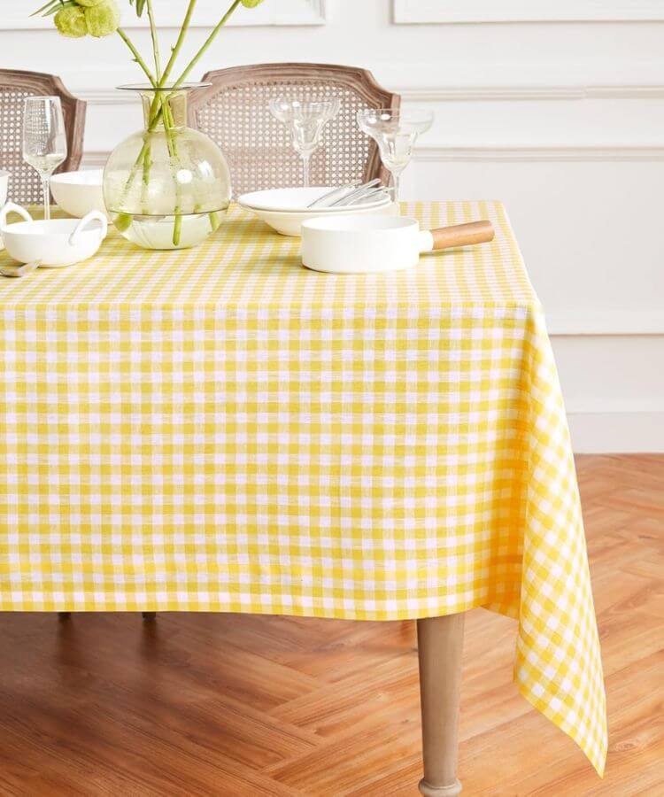 Linen tablecloth featuring a yellow and white gingham check pattern.