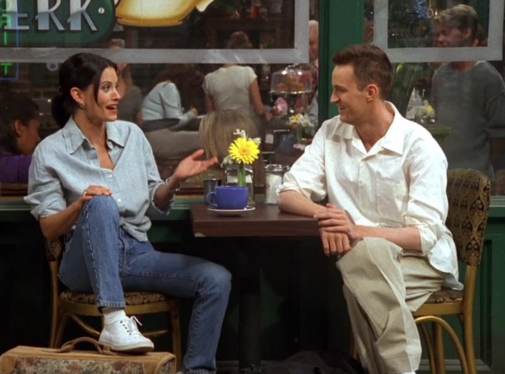 Screengrab of Monica Geller in a light wash denim shirt and jeans.