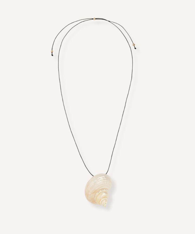 A sculptural black pendant necklace with a thick cord.