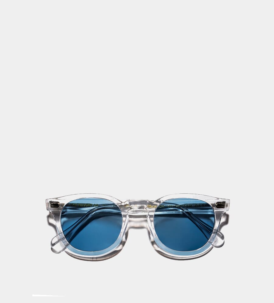 Clear acetate sunglasses with blue-tinted lenses.