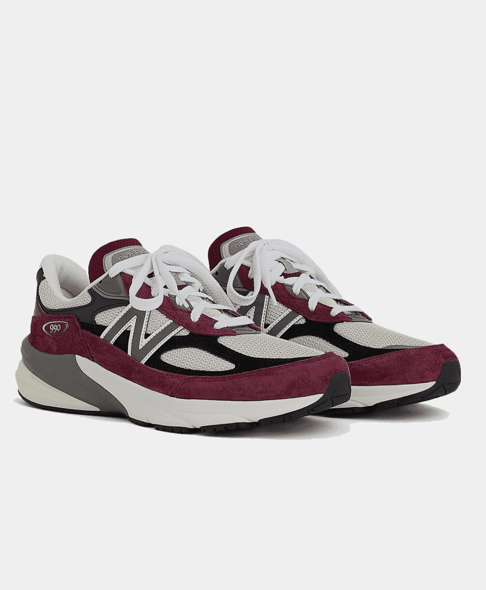 A pair of New Balance 990 running sneakers in burgundy, grey, and white.