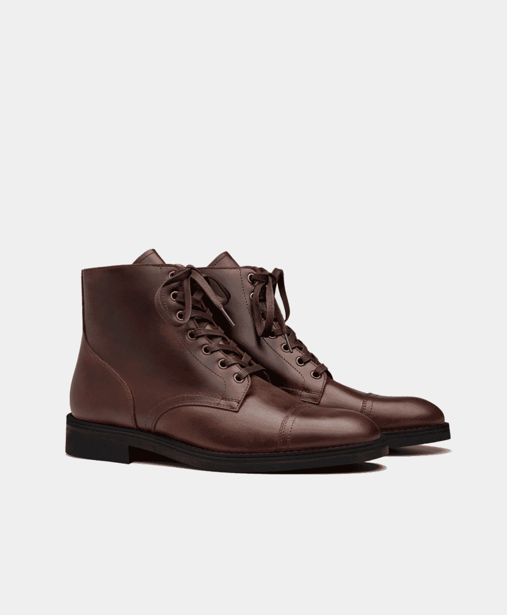A pair of brown leather lace-up ankle boots with cap toe detailing.