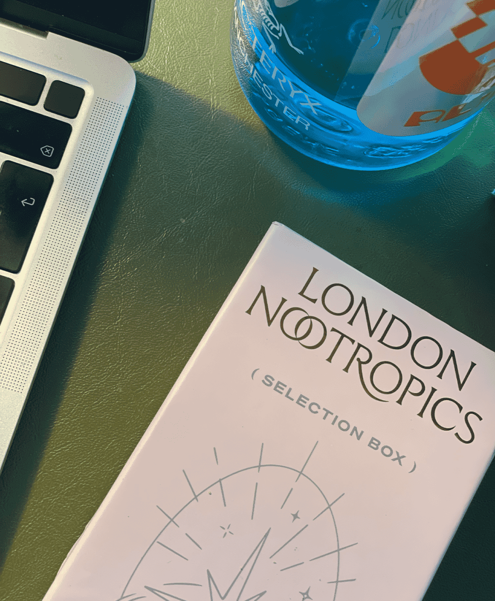 A London Nootropics selection box on a green desk next to a laptop.