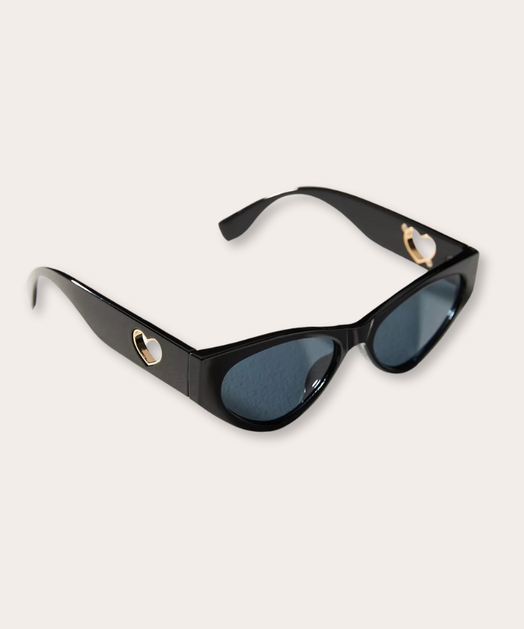 Heart-shaped cutout sunglasses in a pink frame.