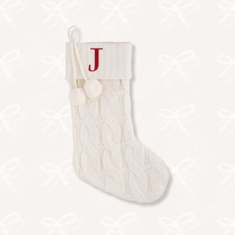 Cream-colored cable knit Christmas stocking.
