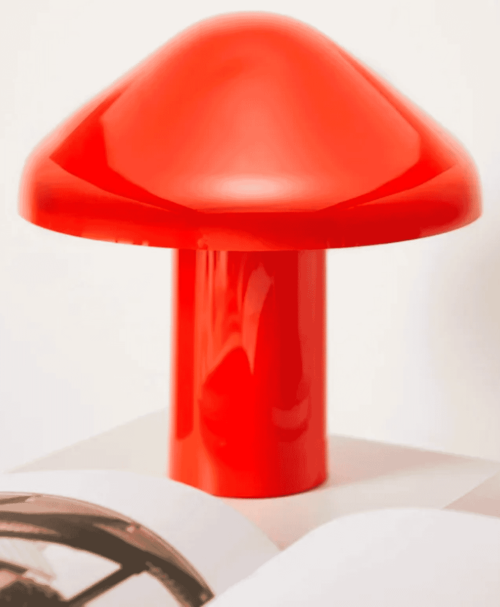 A glossy red HAY mushroom-shaped table lamp on a white surface.