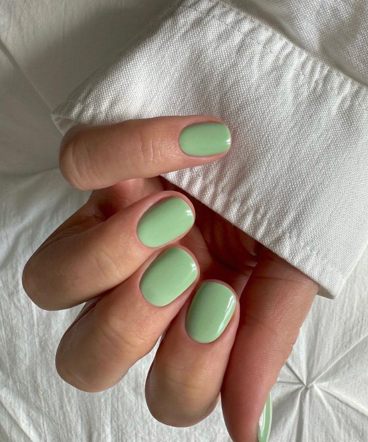 Soft matcha green manicure on rounded nails.