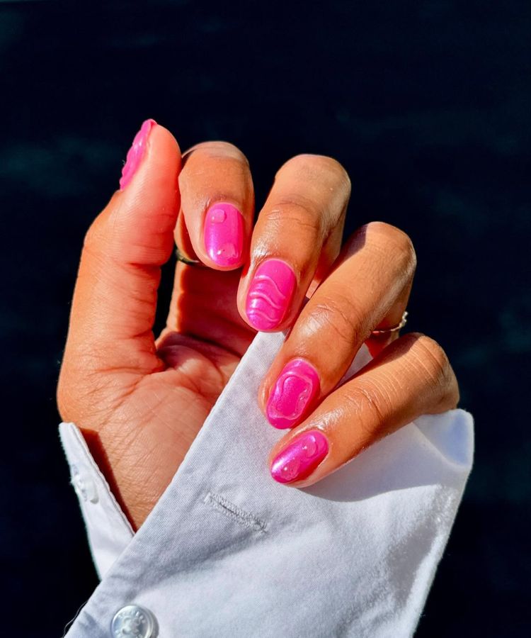 Close-up of nails featuring a lilac and pink aura airbrushed design.