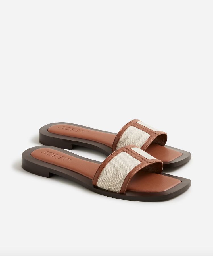 Natural canvas flat sandals with simple straps.