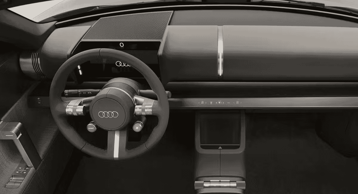 Close-up of the Audi concept car dashboard and steering wheel featuring the Audi logo.