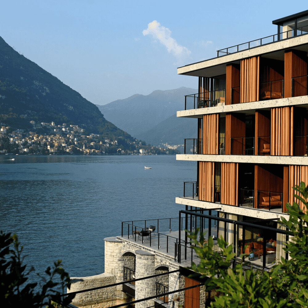 Modern luxury apartment building with wooden balconies overlooking the lake.