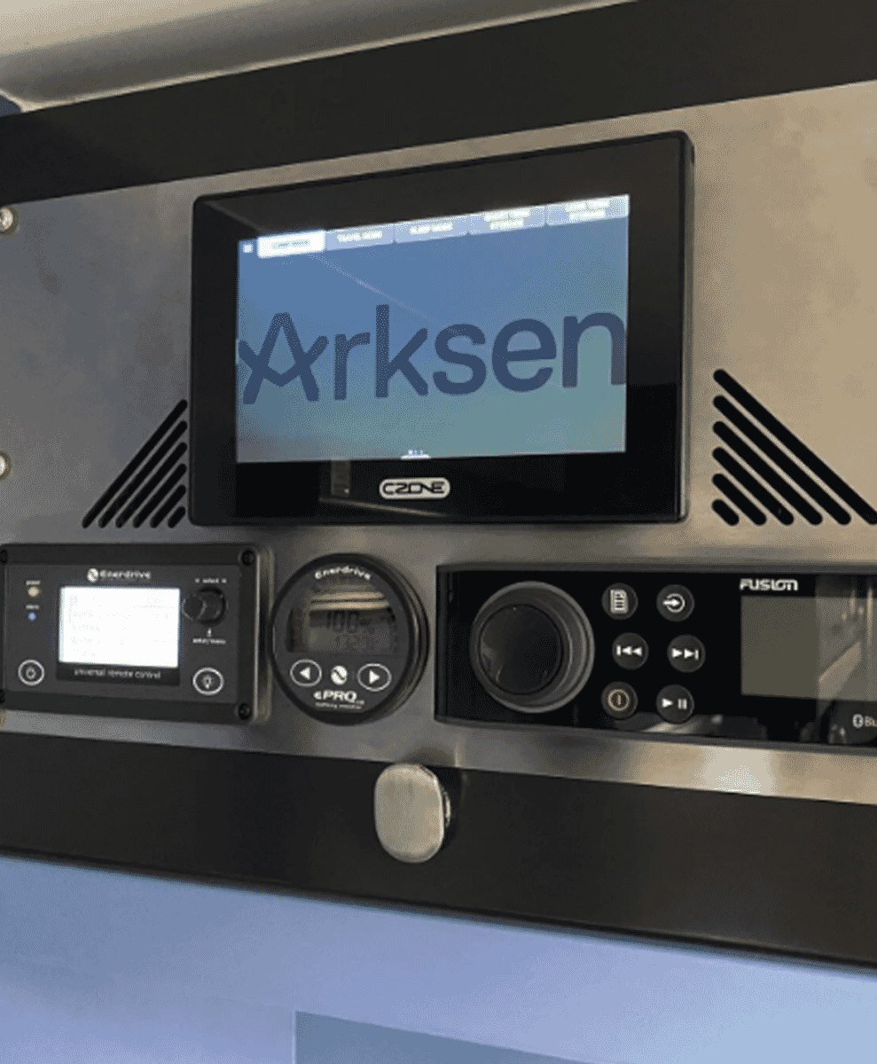 A high-tech Arksen-branded control panel with digital displays for audio and vehicle systems.