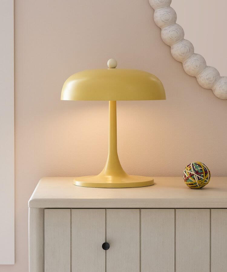 Modern metal table lamp in a pale yellow finish.