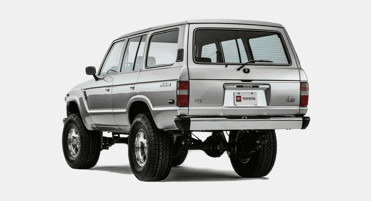 Rear three-quarter angle of a silver Toyota 4x4 SUV with off-road tires.