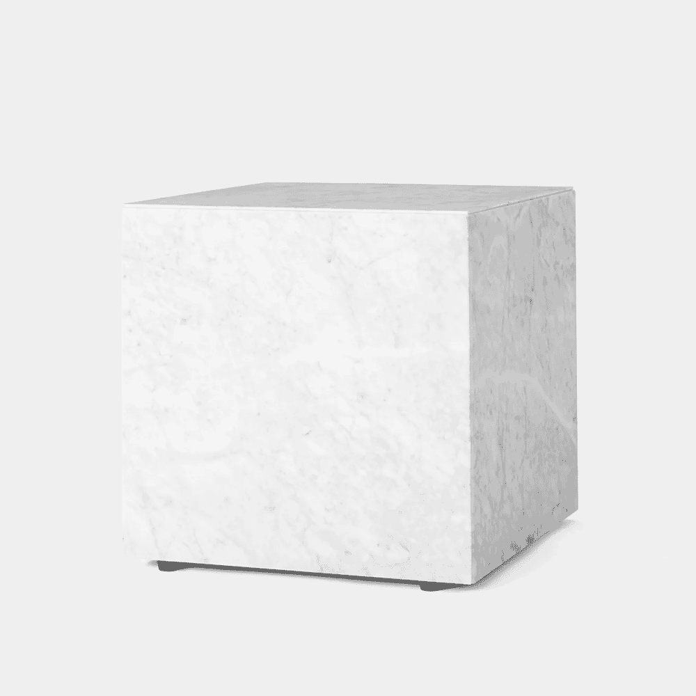 A minimalist white marble cube with subtle gray veining.