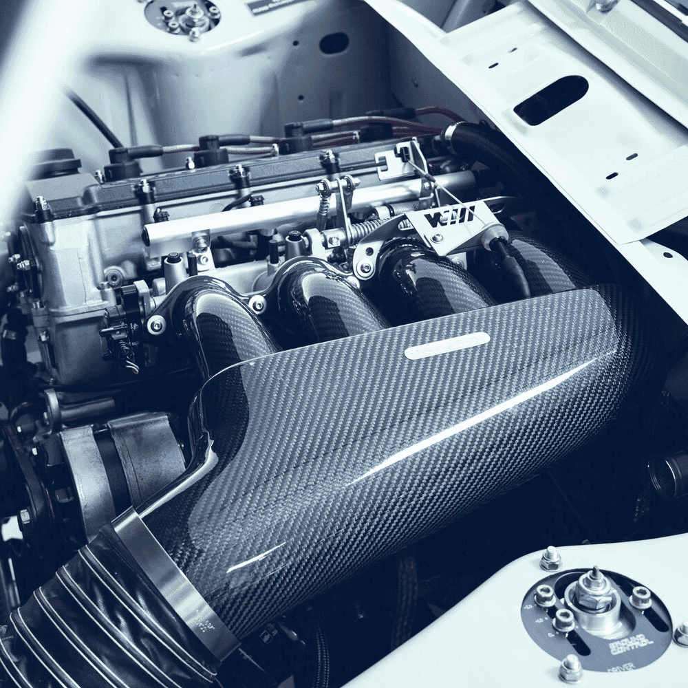 Engine bay detail featuring a carbon fiber intake manifold and high-performance components.