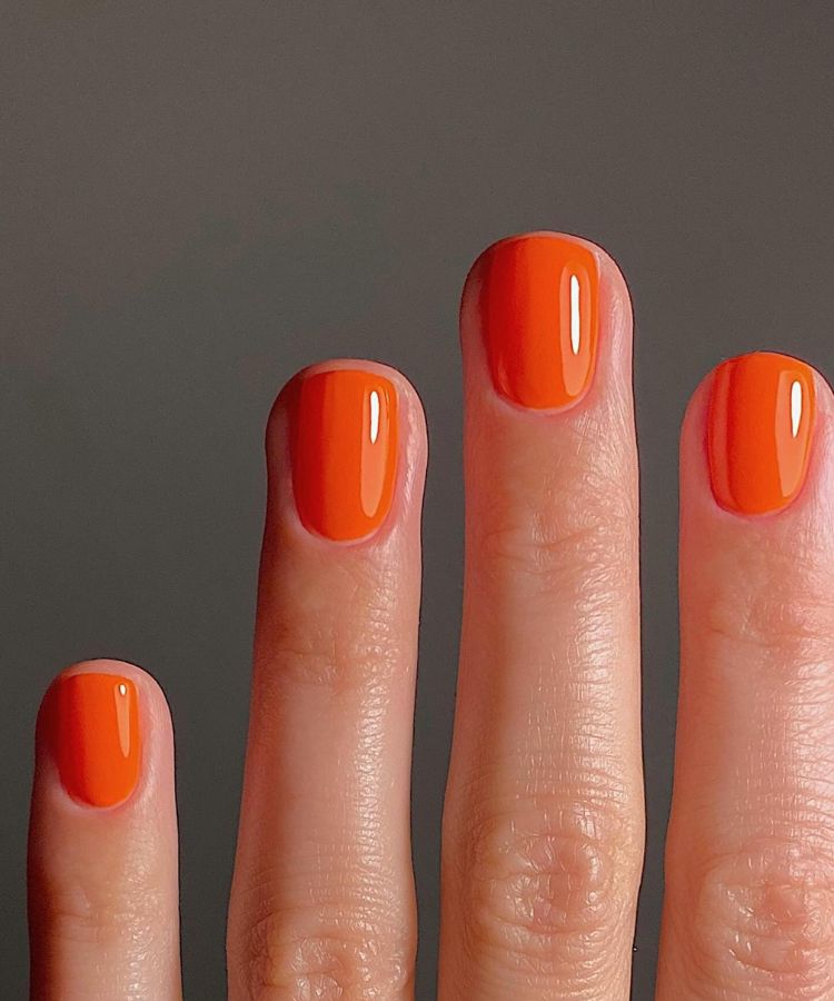 Electric sunset orange manicure with high shine.