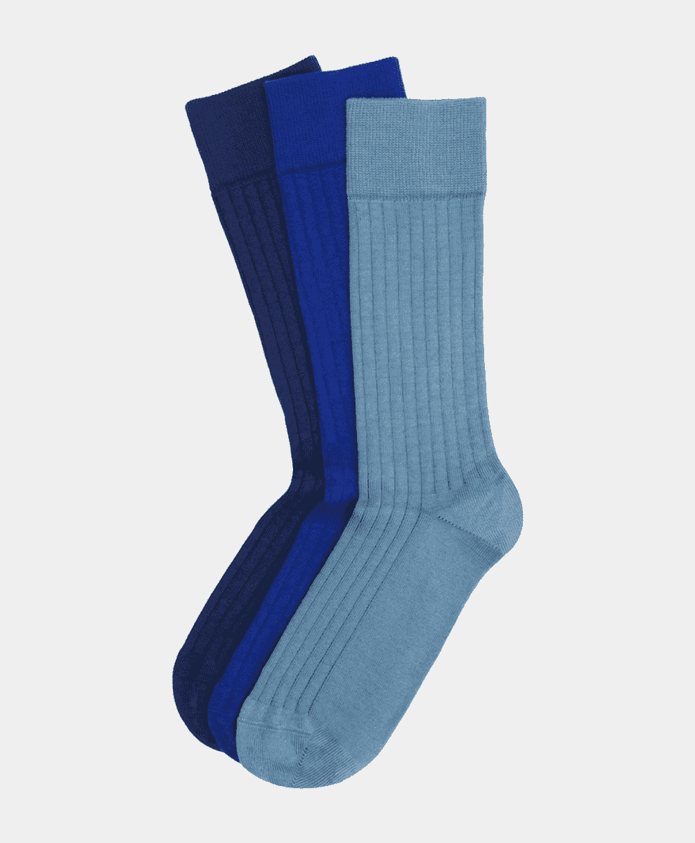 Three pairs of ribbed men's dress socks in shades of blue.