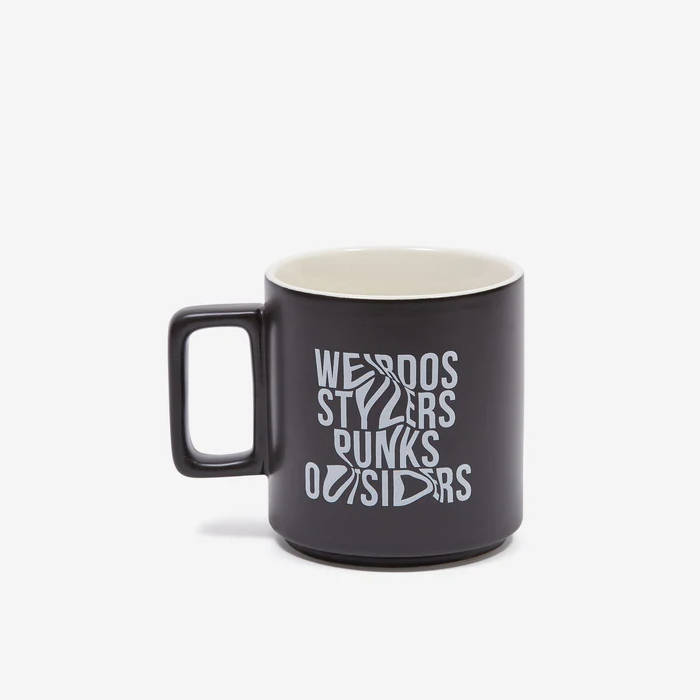 Black ceramic mug with white text reading 'WEIRDOS STYLERS PUNKS OUTSIDERS'.