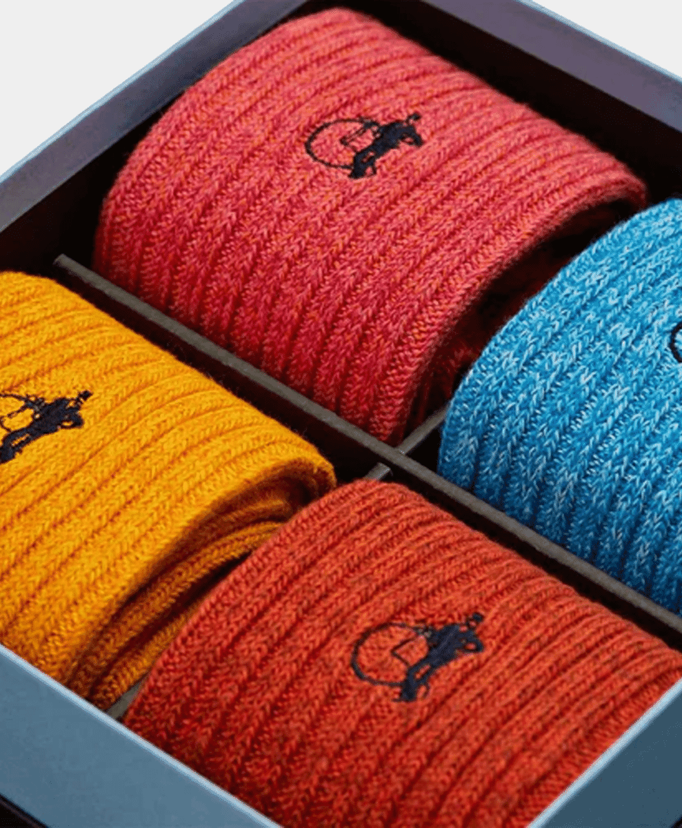 A 4-pack of ribbed knit socks in orange, red, yellow, and blue.