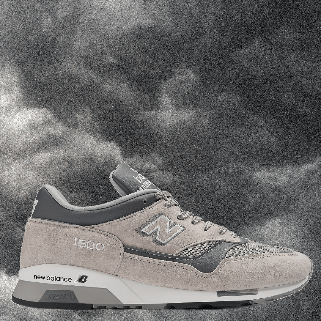 Gray and beige New Balance 1500 sneaker against a dark, moody monochrome background.